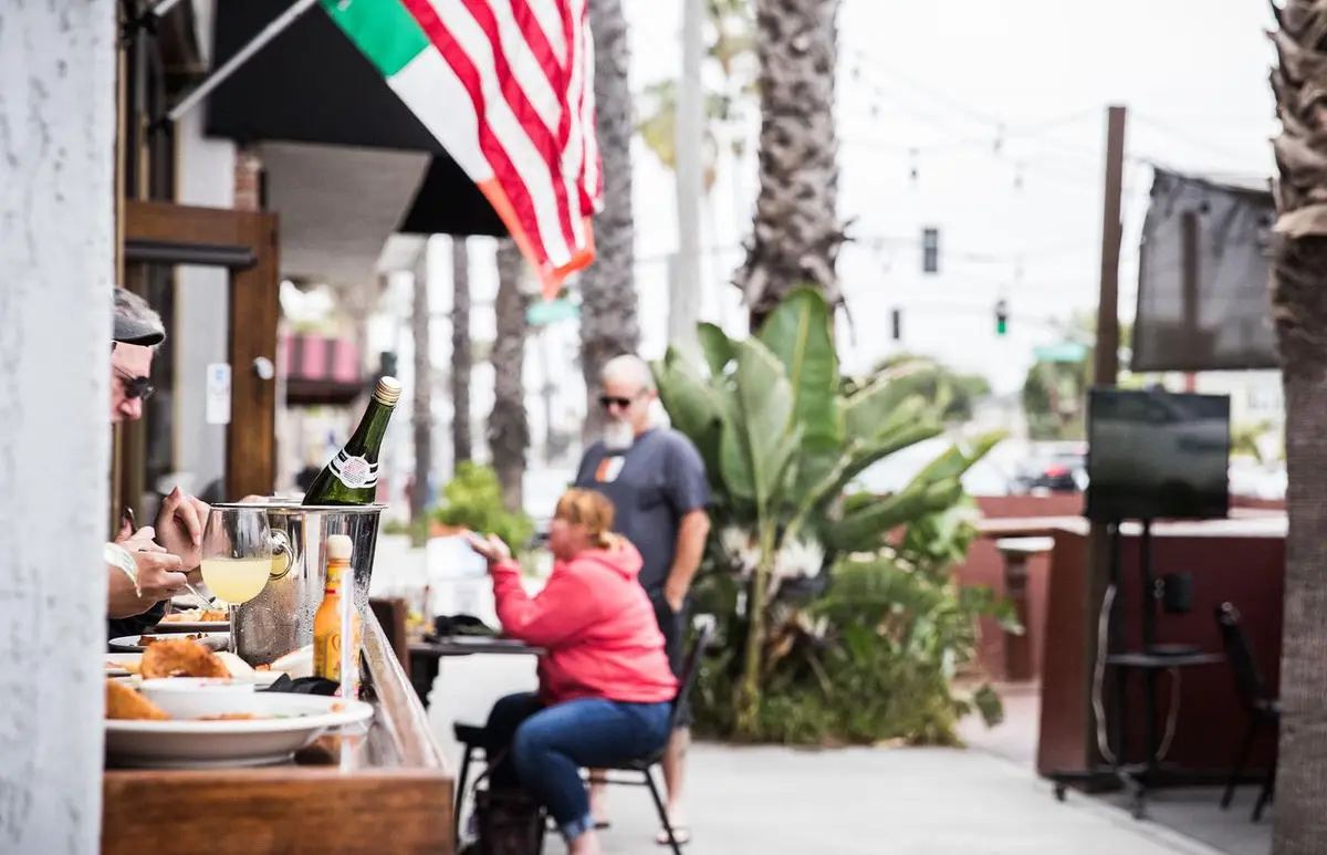 Guests enjoying brunch with champagne on the patio along Second Street