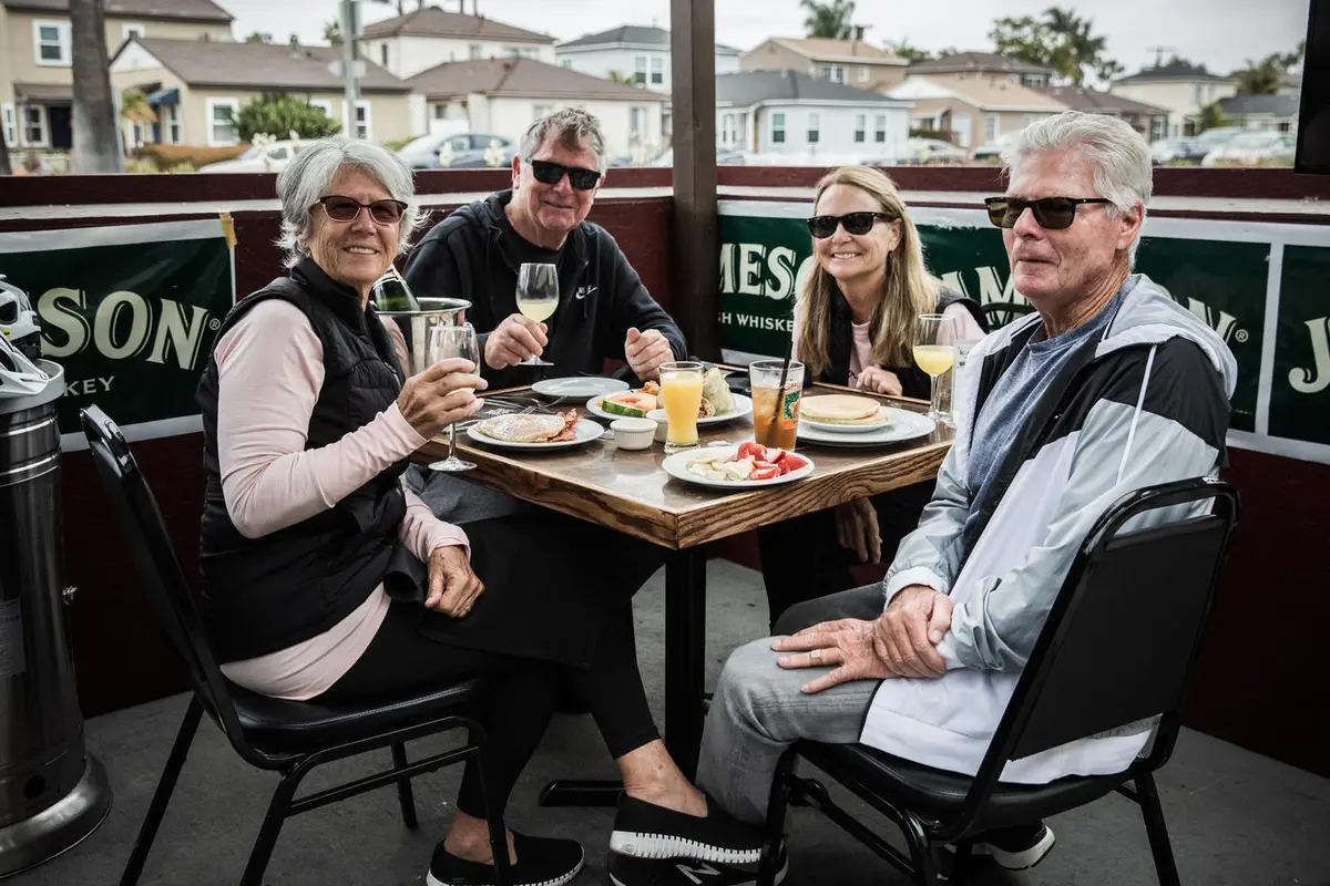 Friends sharing lunch and wine on the patio